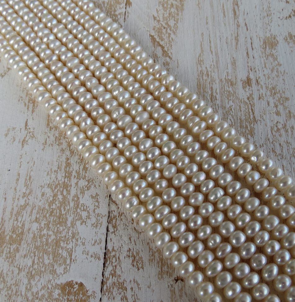 Small disc shaped smooth Freshwater Pearl beads by string