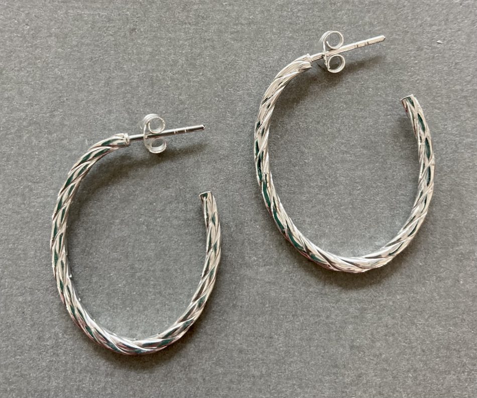 Sterling silver twist detailed oval hoop earrings