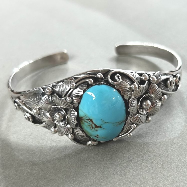 Sterling silver flower detail and oval Turquoise cuff bangle