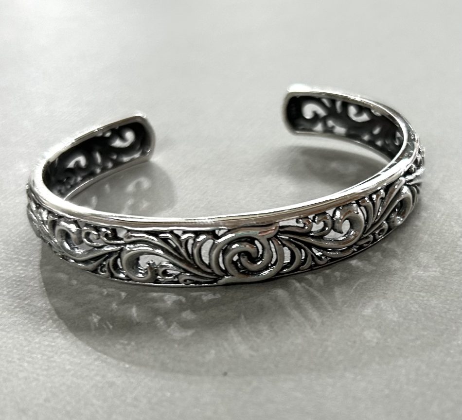 Sterling silver cuff bangle with intricate swirled details