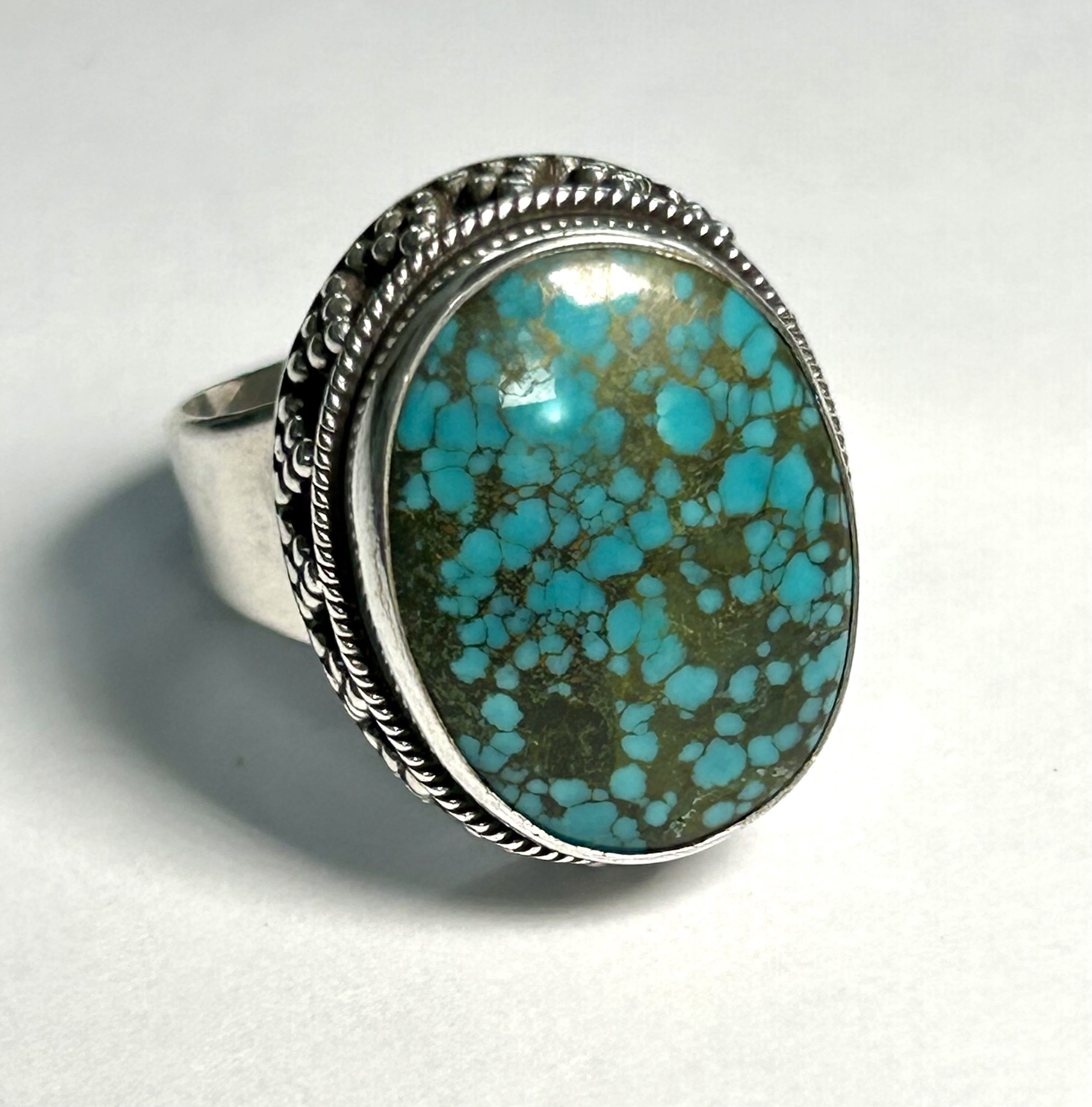 oval turquoise ring with dotted sterling silver border and band