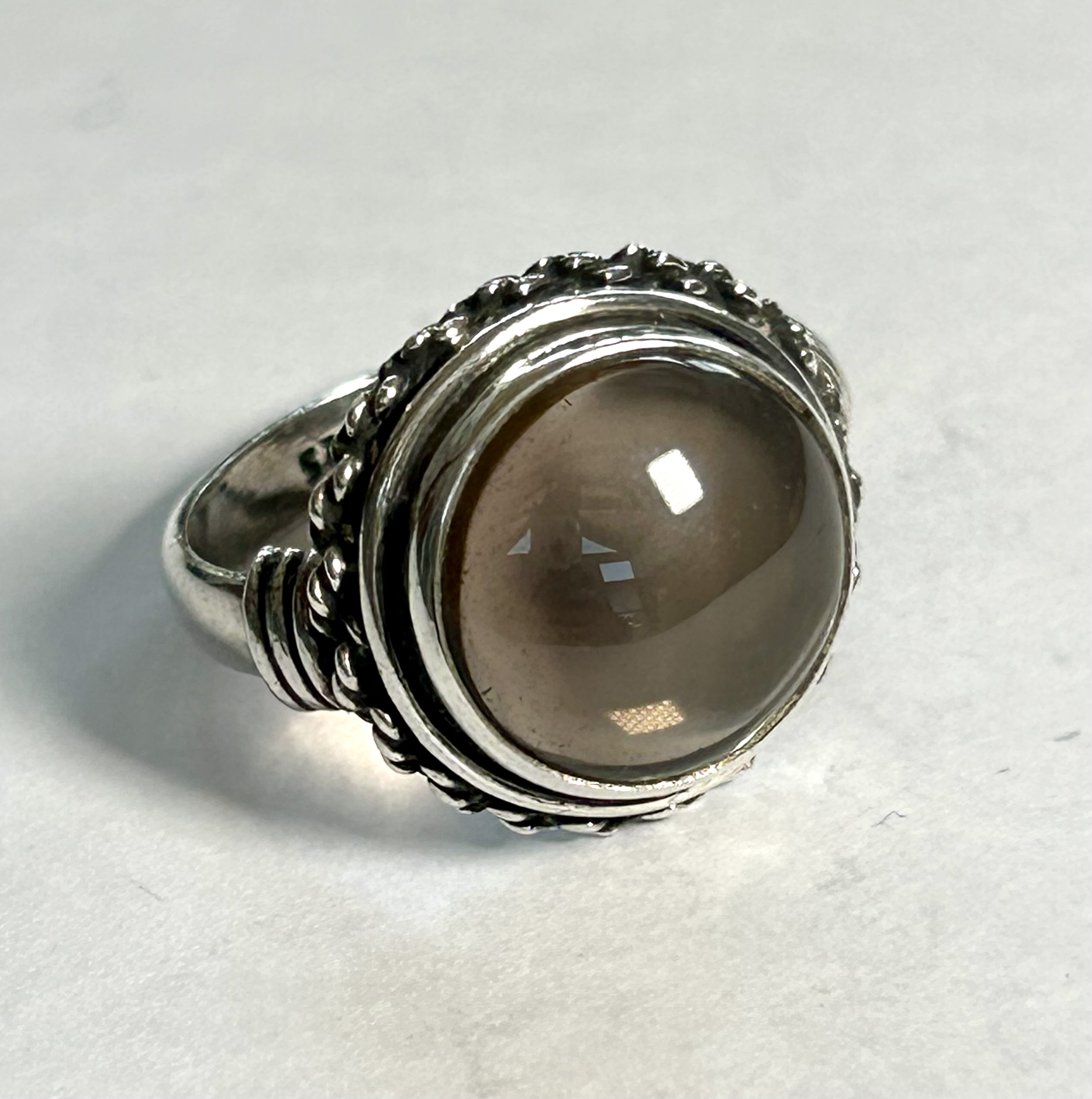 round cabochon smokey quartz ring with sterling silver border