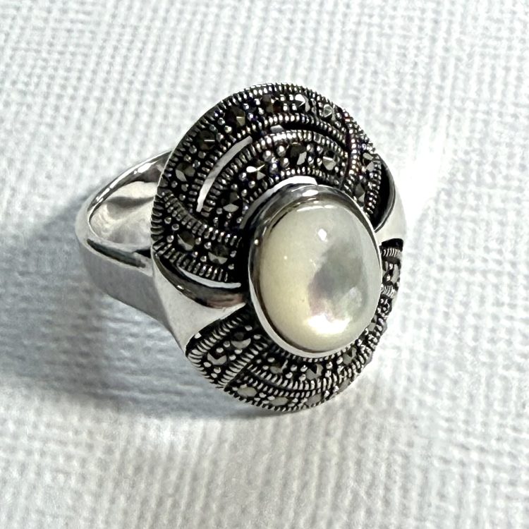 sterling silver and mother of pearl ring with decorative marcasite border