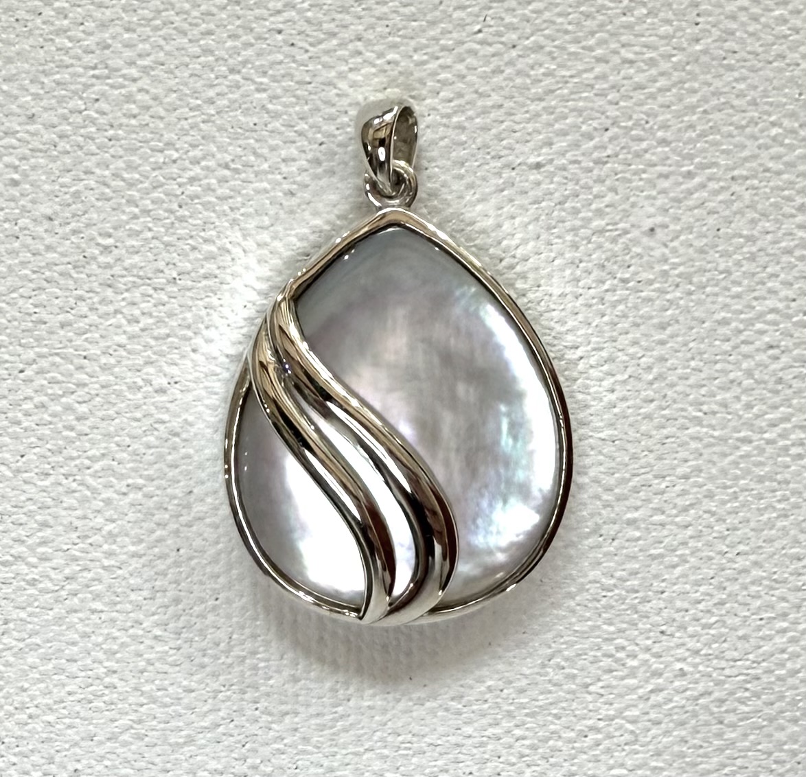 modern teardrop mother of pearl pendant with double sterling silver waves