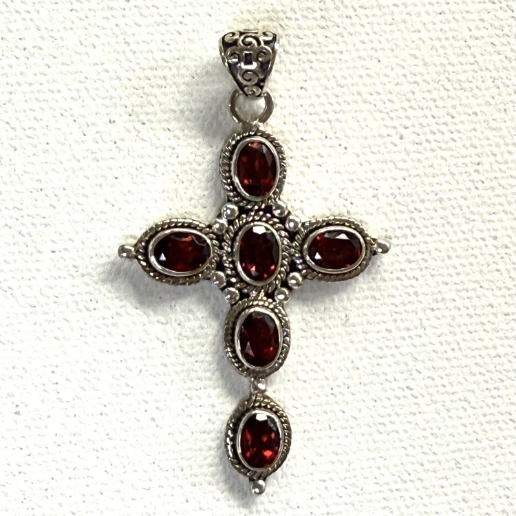 detailed sterling silver and faceted garnet cross pendant