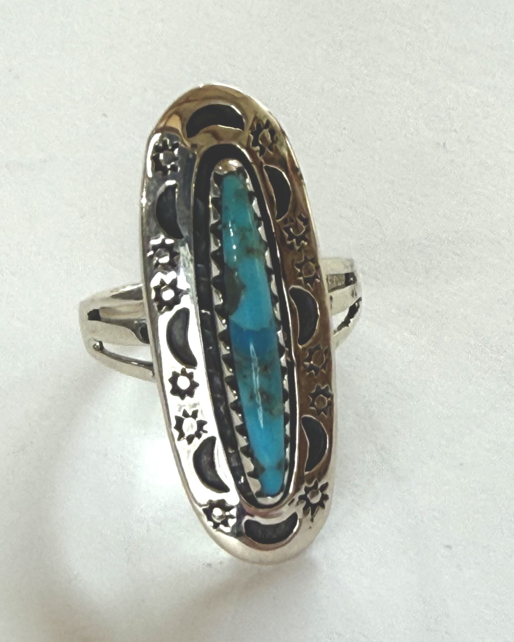 elliptical turquoise with sterling silver sun and moon border ring