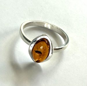 small oval amber ring with sterling silver border