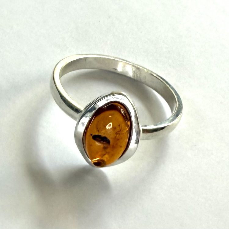 small oval amber ring with sterling silver border